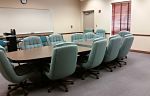 Image of board room with table and chairs.